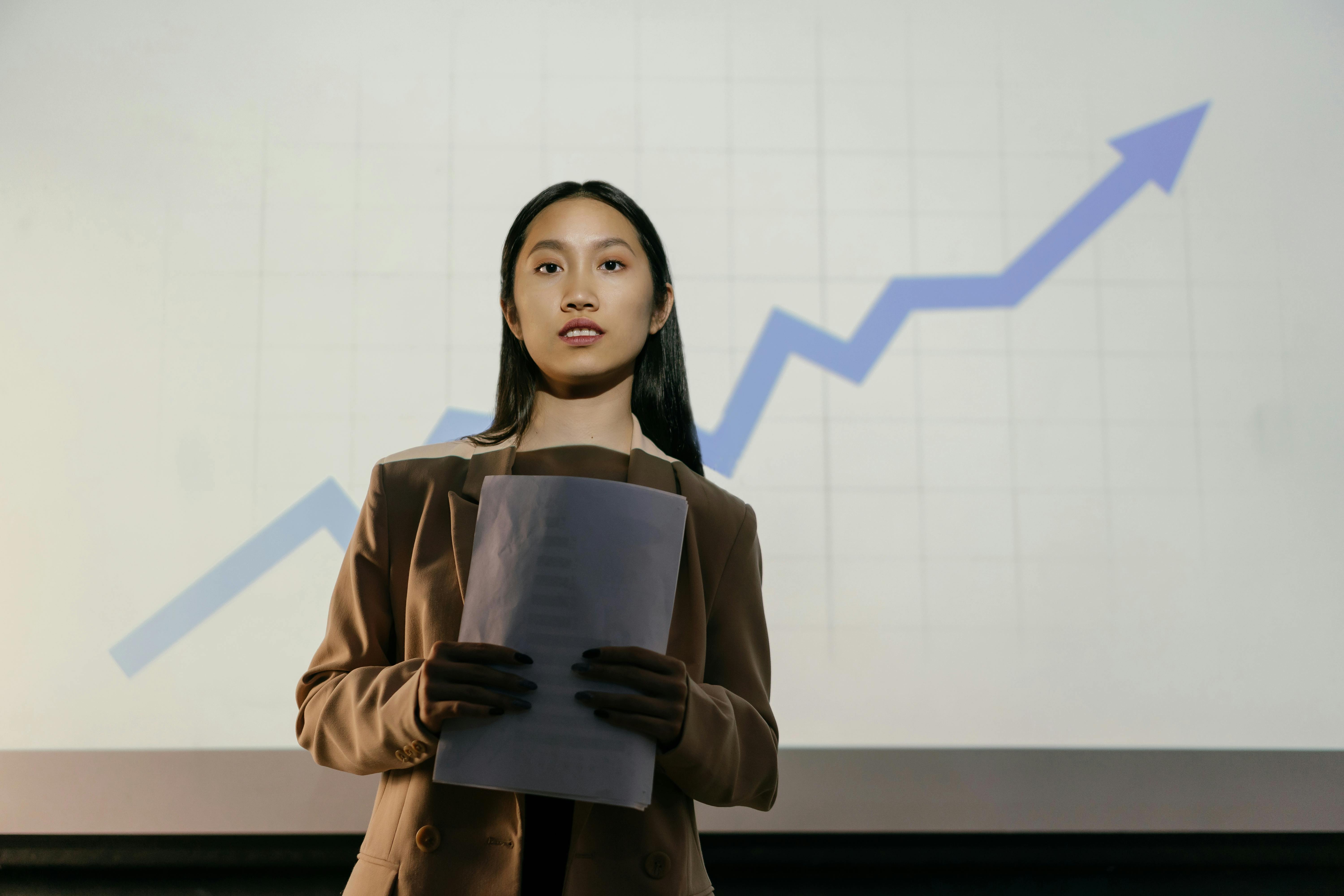 Professional businesswoman holding documents with upward trending growth chart in background representing business success and financial growth